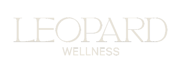 Leopard Wellness logo in warm alabaster on dark background