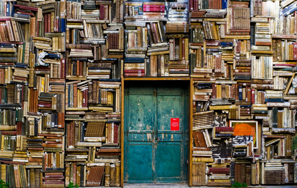 Wall of old books and a blue door