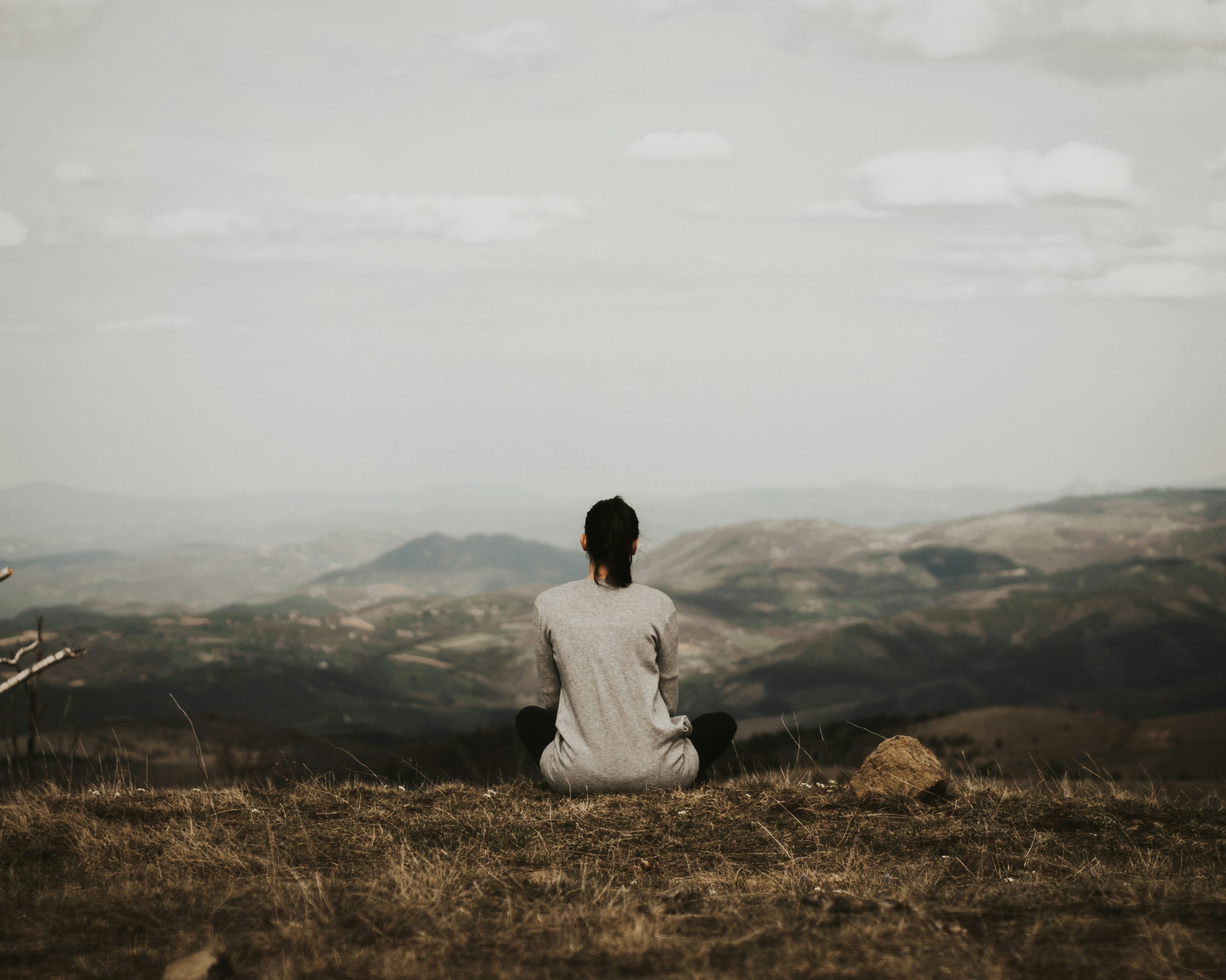 Woman looking out from mountaintop