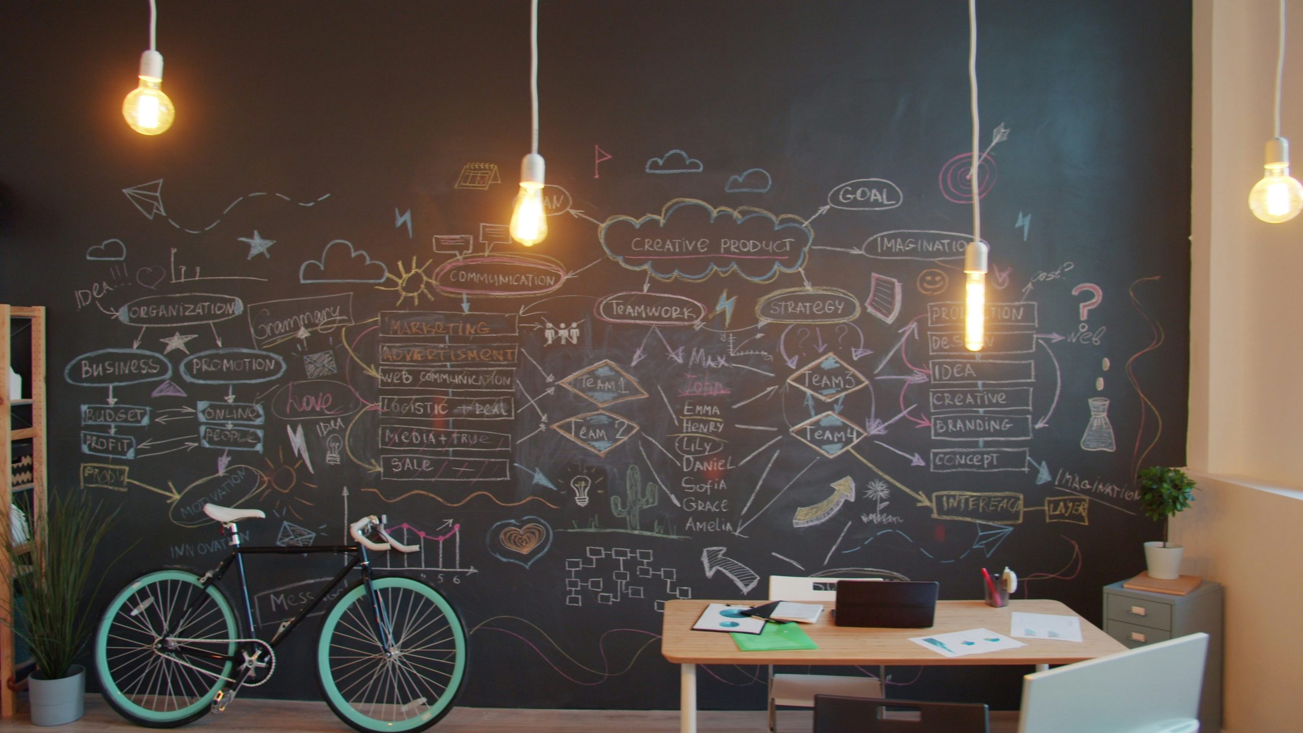 Co-working space with blackboard wall, desks, and bike